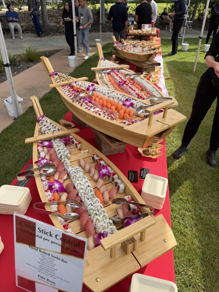 fancy wood boats loaded with sushi for a wedding reception